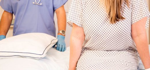 A woman sits on a bed. Laparoscopy recovery tips.
