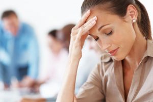 woman has a headache because of a sinus cyst