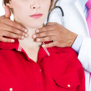 A doctor examine a patient to decide on thyroid cyst treatment&